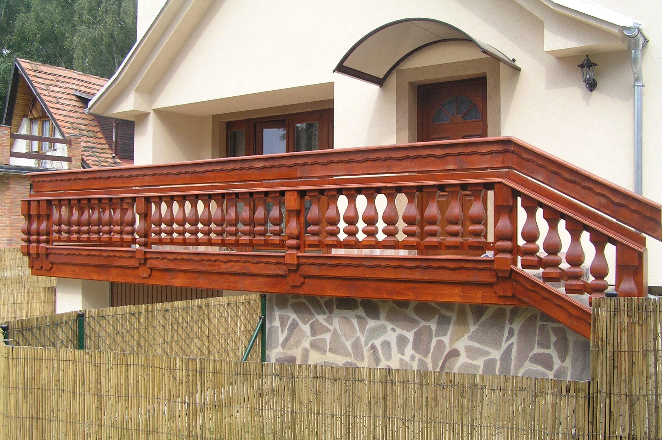 Dřevěný balkon na míru s nosnou konstrukcí a zábradlím u rodinného domu